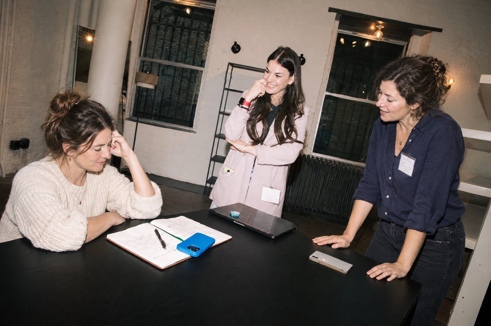 Vix Reitano in a working session at a table with an open notebook